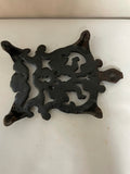 ~ Vintage Black Cast Iron Trivet Hot Plate Ornate Angels Cherubs Pattern Footed